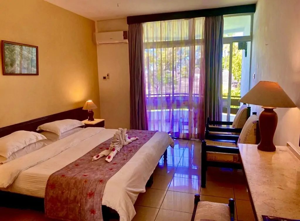 Superior double room interior with balcony at Kenya Bay Beach Hotel, Mombasa